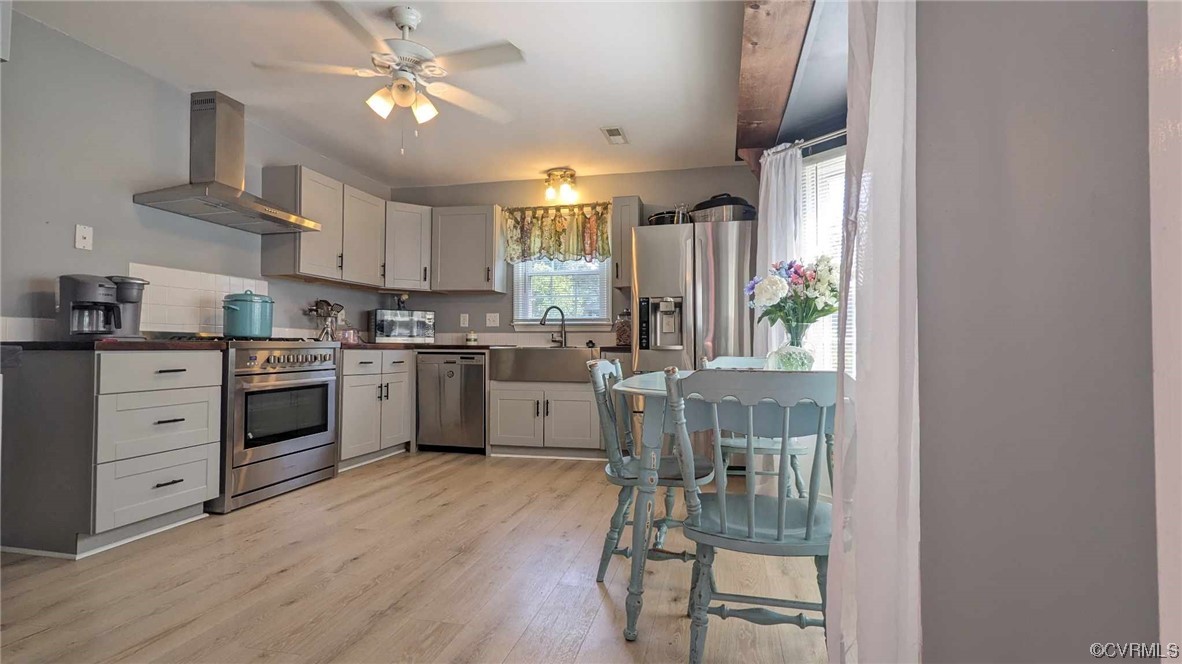 10770 Old Centralia Road Chester, VA 23831 - Photo 3 of 25 a kitchen with a stove a sink and a refrigerator