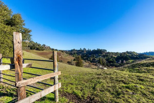 a view of a wooden fence with a mountain view