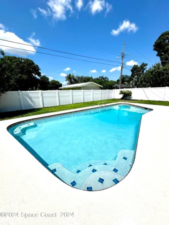 a view of swimming pool with outdoor seating