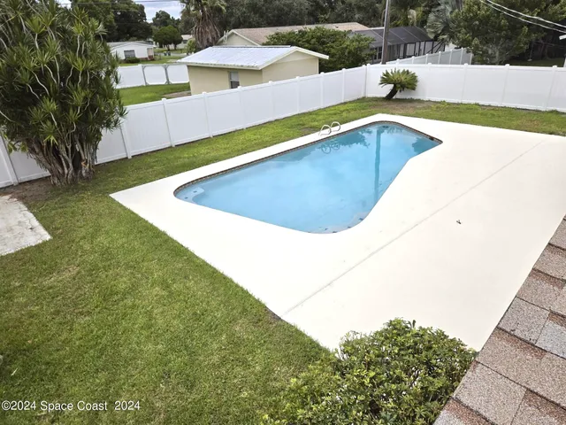 a view of a swimming pool with a yard