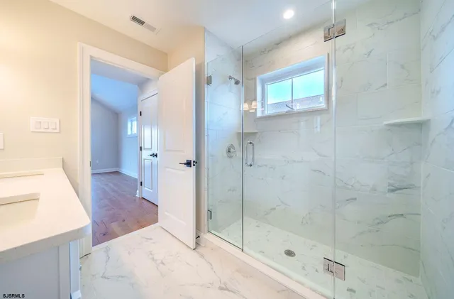 a bathroom with a bathtub and a shower