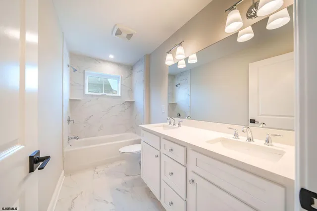 a bathroom with a sink a tub and a mirror