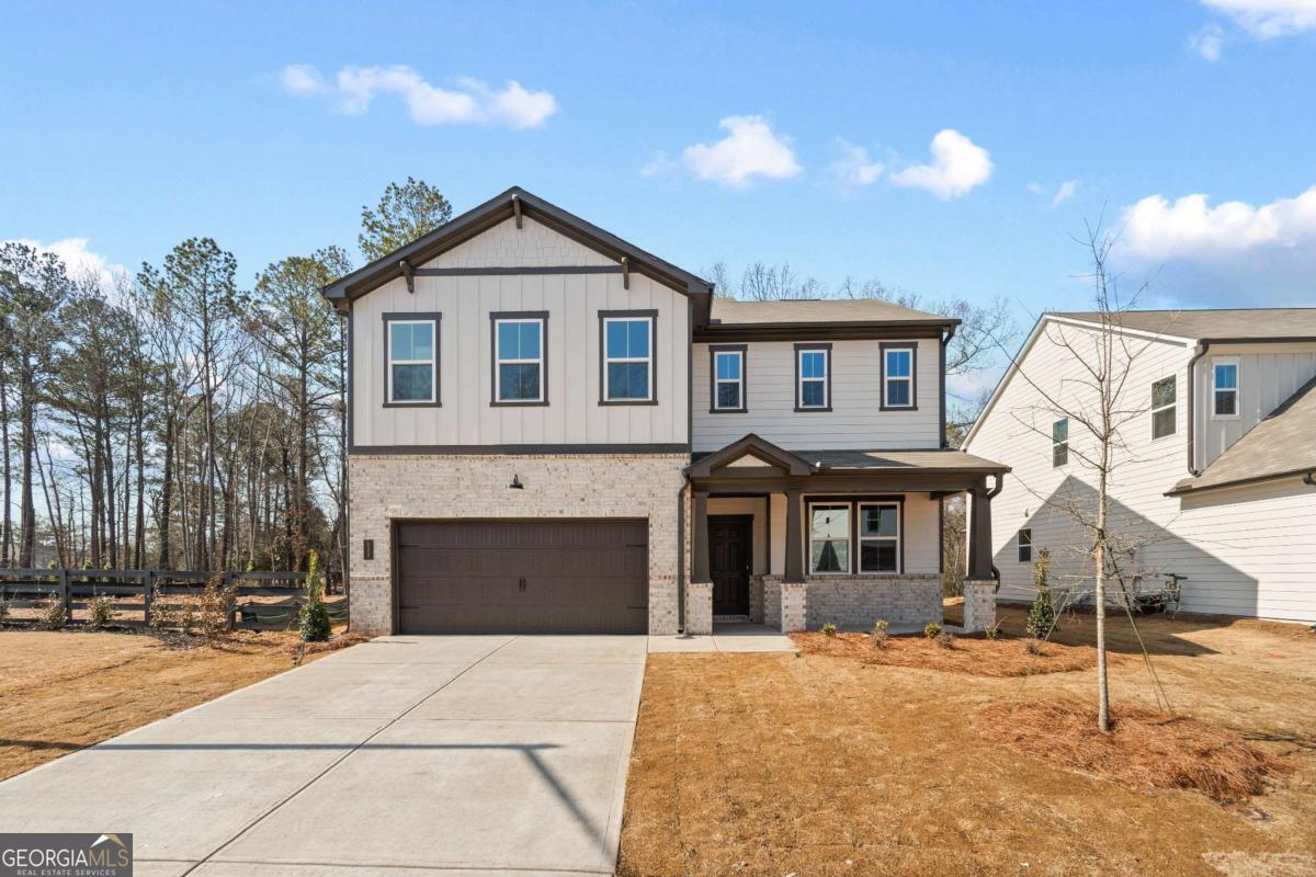 147 Henley Street, Unit 63 Canton, GA 30114 - Photo 1 of 36 a front view of a house with a yard and garage