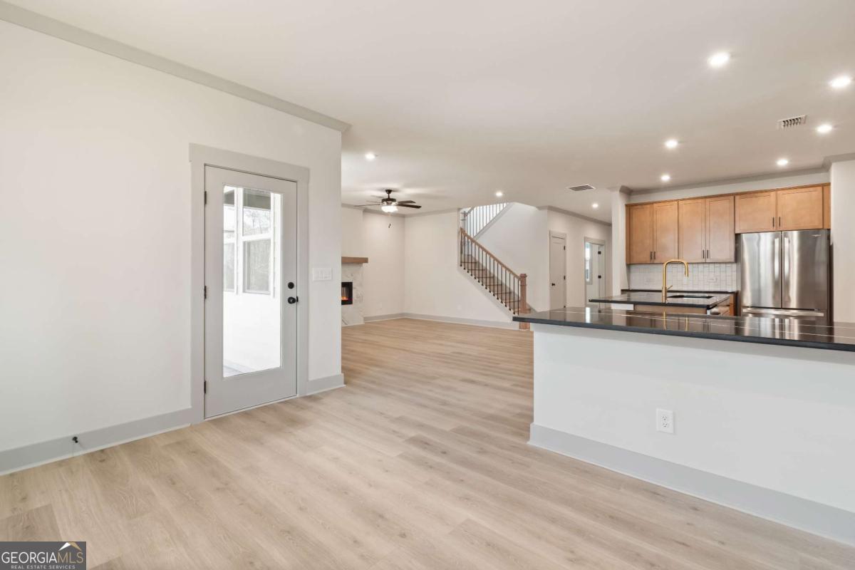 147 Henley Street, Unit 63 Canton, GA 30114 - Photo 15 of 36 an empty room with wooden floor and windows