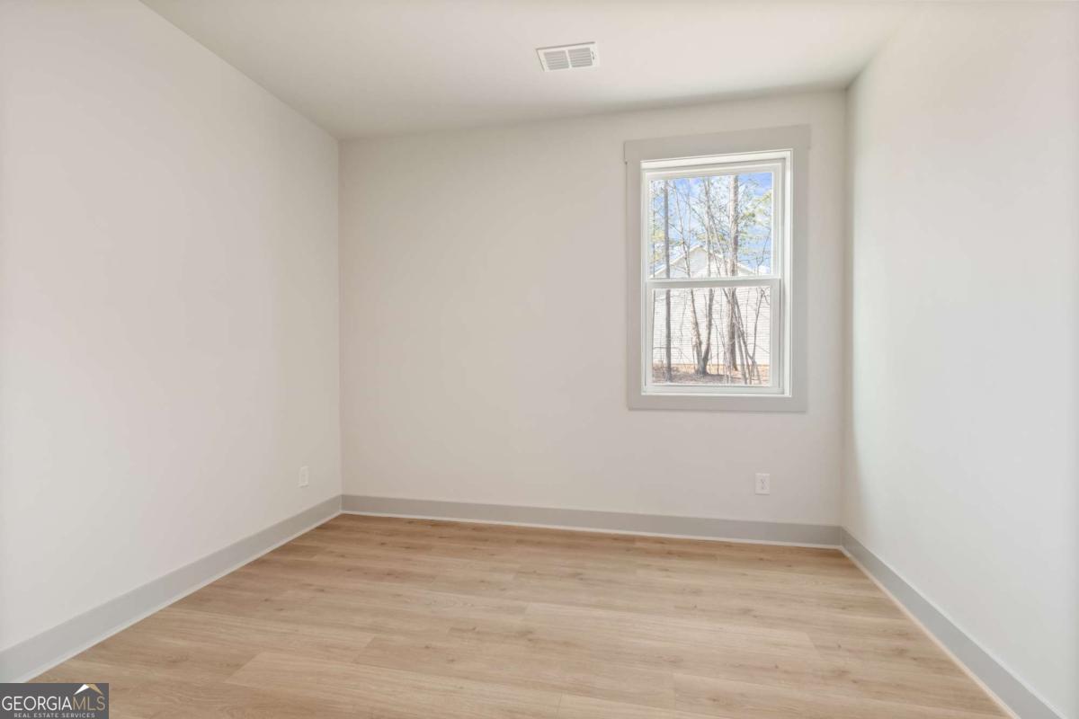 147 Henley Street, Unit 63 Canton, GA 30114 - Photo 20 of 36 an empty room with a window