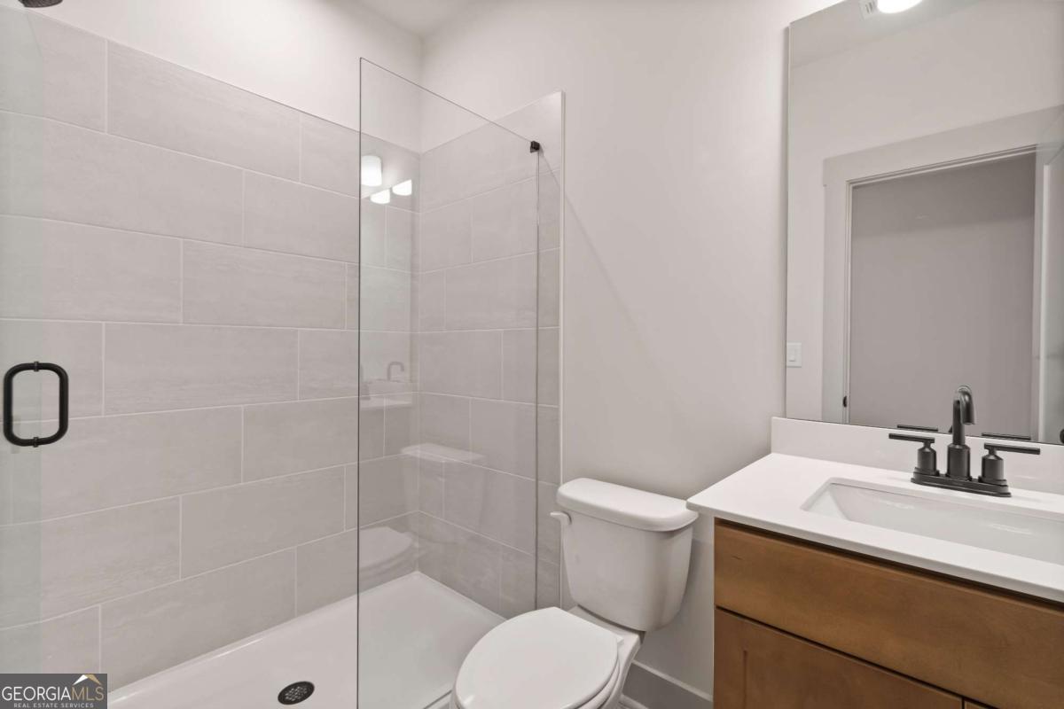 147 Henley Street, Unit 63 Canton, GA 30114 - Photo 21 of 36 a bathroom with a sink a toilet and shower