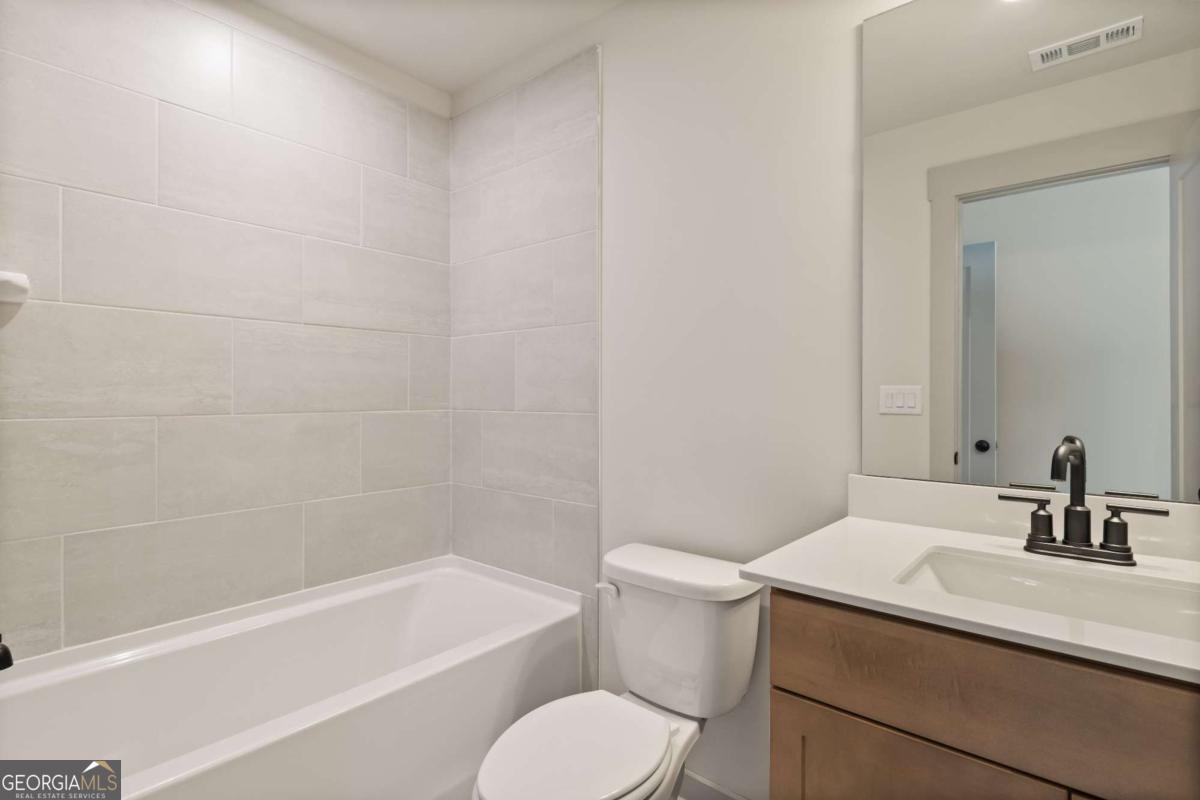 147 Henley Street, Unit 63 Canton, GA 30114 - Photo 25 of 36 a bathroom with a sink a toilet and bathtub