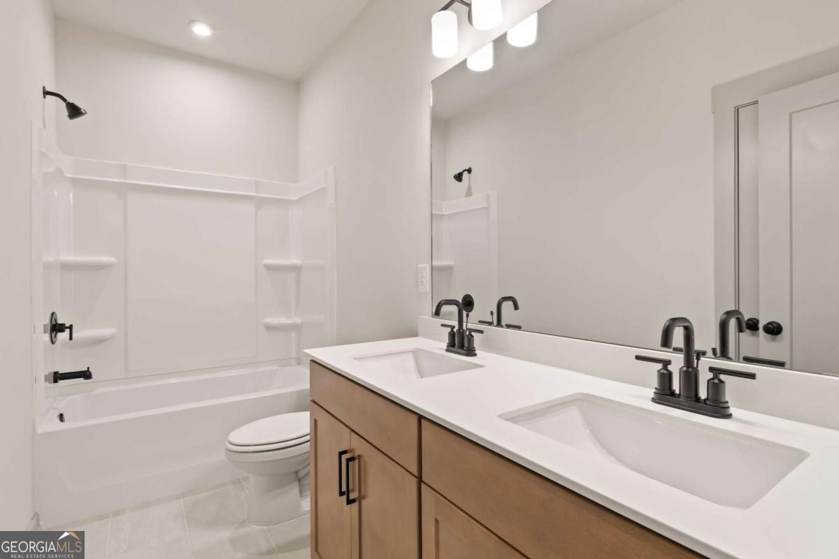 147 Henley Street, Unit 63 Canton, GA 30114 - Photo 26 of 36 a bathroom with a sink a toilet and shower