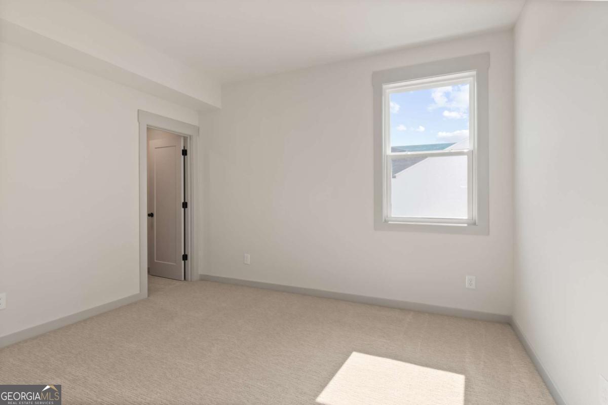147 Henley Street, Unit 63 Canton, GA 30114 - Photo 27 of 36 an empty room with windows and closet