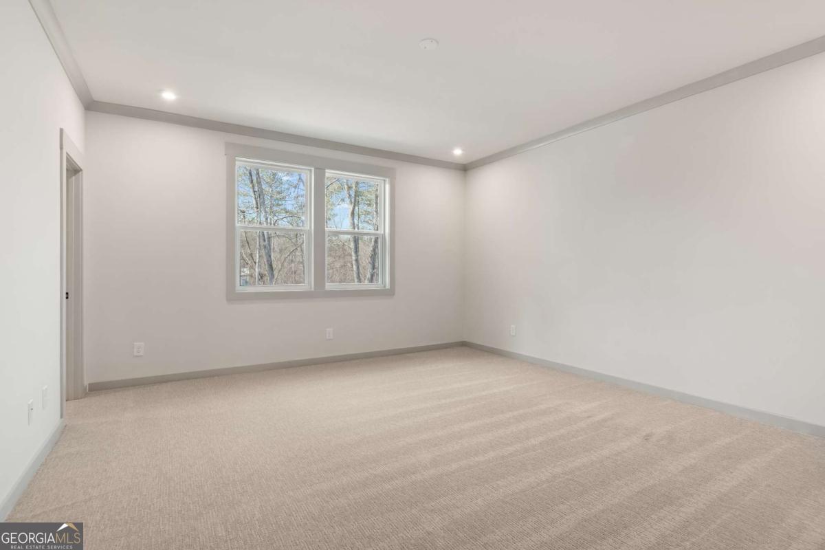 147 Henley Street, Unit 63 Canton, GA 30114 - Photo 30 of 36 an empty room with windows