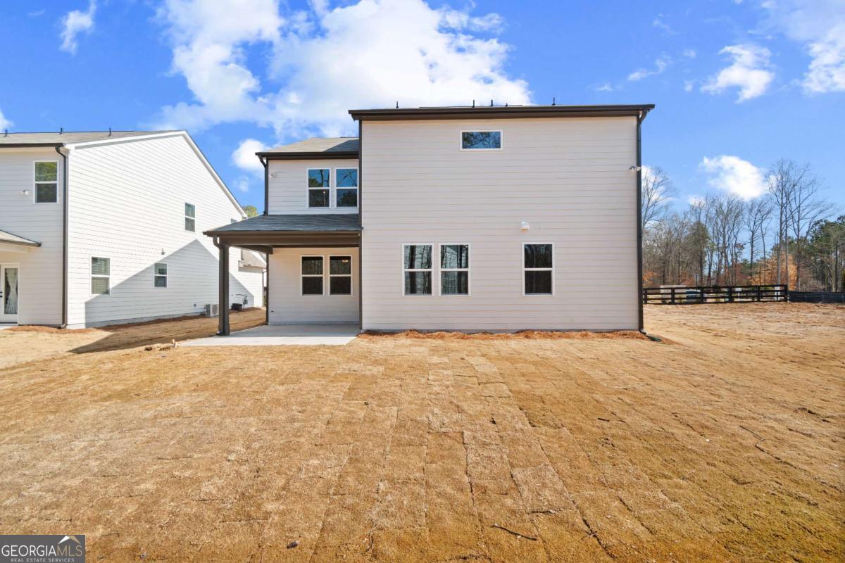 147 Henley Street, Unit 63 Canton, GA 30114 - Photo 3 of 36 a front view of a house with a yard