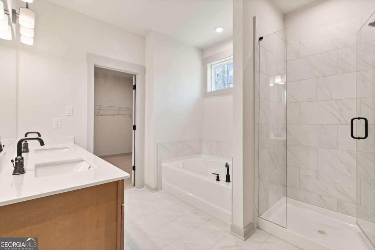 147 Henley Street, Unit 63 Canton, GA 30114 - Photo 32 of 36 a bathroom with a bathtub sink and mirror
