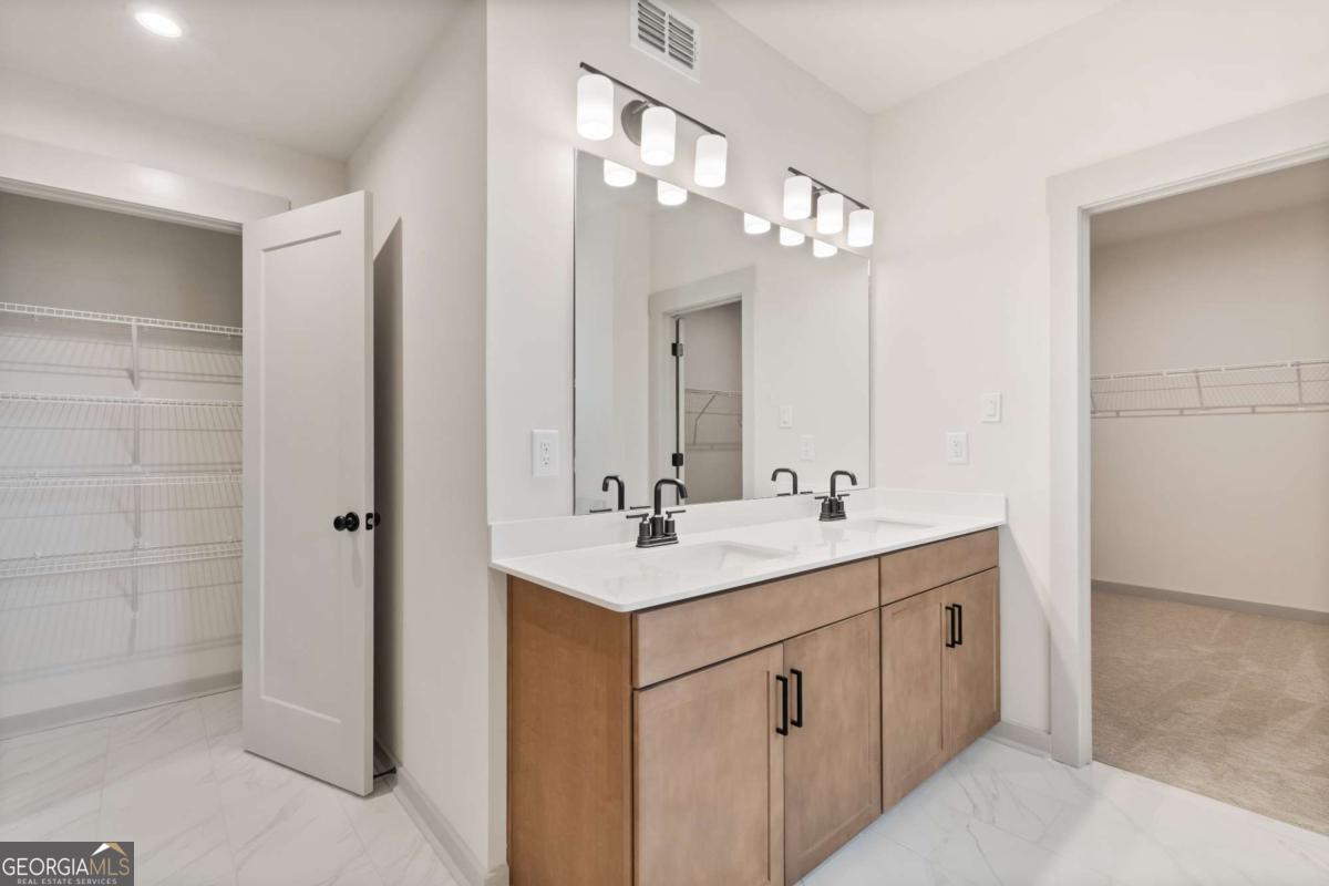147 Henley Street, Unit 63 Canton, GA 30114 - Photo 33 of 36 a bathroom with a sink a light fixture a vanity and a mirror