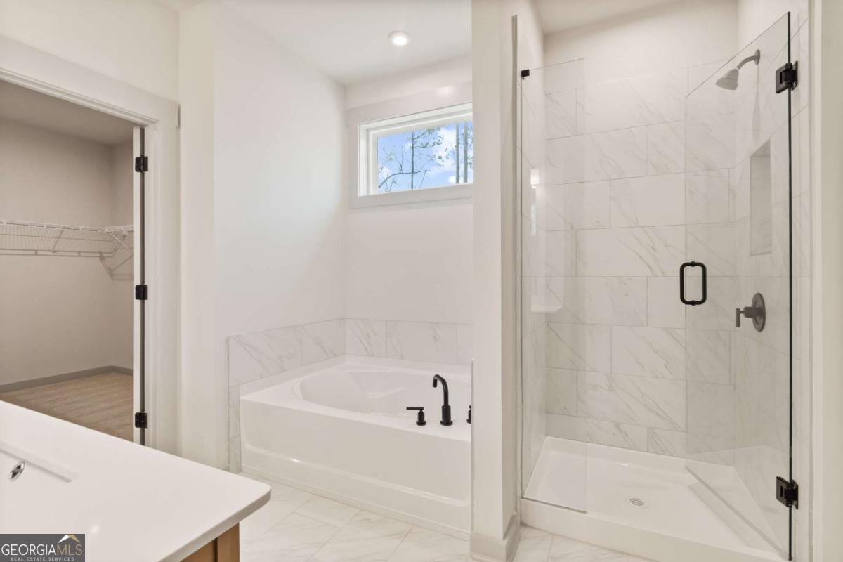 147 Henley Street, Unit 63 Canton, GA 30114 - Photo 34 of 36 a white bath tub sitting next to a shower