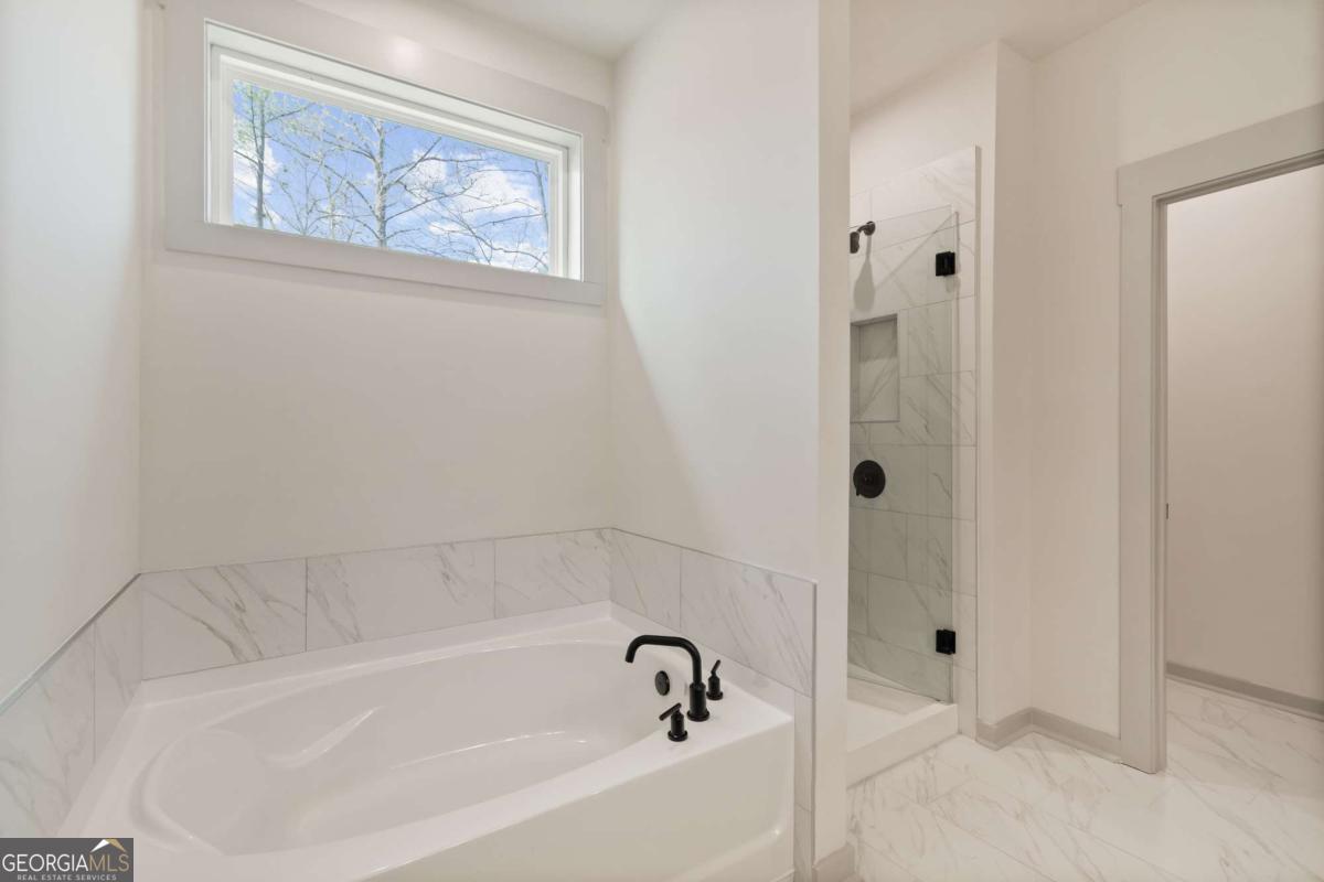 147 Henley Street, Unit 63 Canton, GA 30114 - Photo 35 of 36 a white bath tub sitting next to a shower