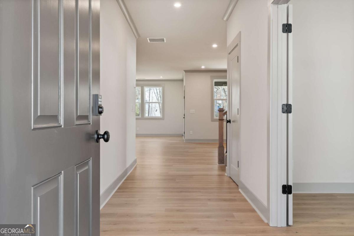 147 Henley Street, Unit 63 Canton, GA 30114 - Photo 4 of 36 a view of a hallway with wooden floor and closet area