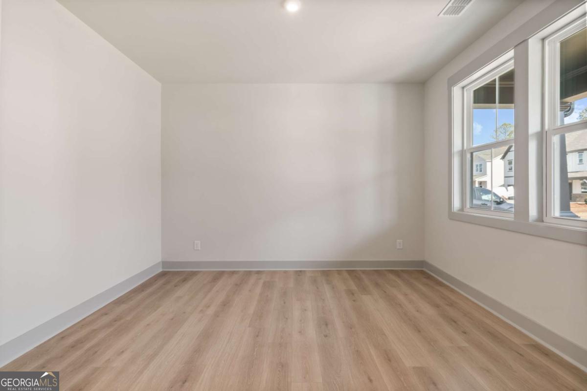 147 Henley Street, Unit 63 Canton, GA 30114 - Photo 5 of 36 an empty room with a window