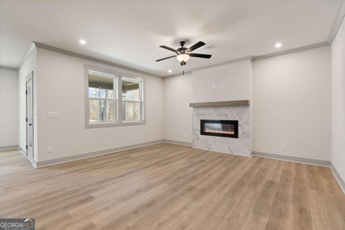147 Henley Street, Unit 63 Canton, GA 30114 - Photo 8 of 36 an empty room with windows and a ceiling fan