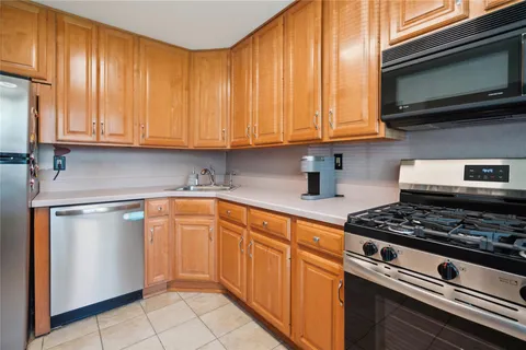 a kitchen with stainless steel appliances granite countertop a sink stove and microwave