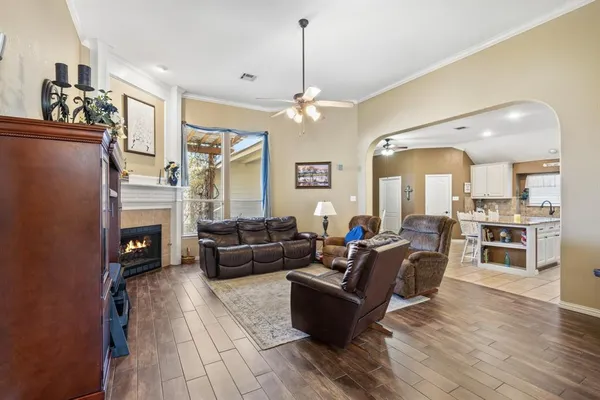 a living room with furniture a fireplace and a flat screen tv