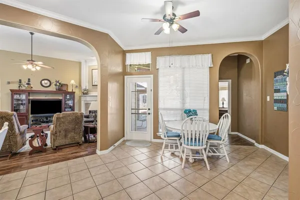 a living room with furniture fireplace and cabinets