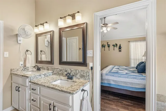 a bathroom with a tub a sink and glass door