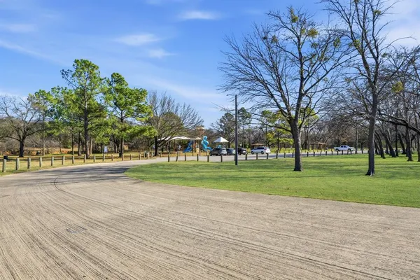 a sign board with tall trees