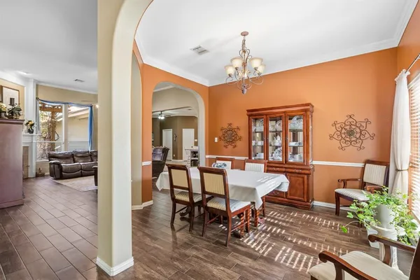 a kitchen with a dining table chairs refrigerator and cabinets
