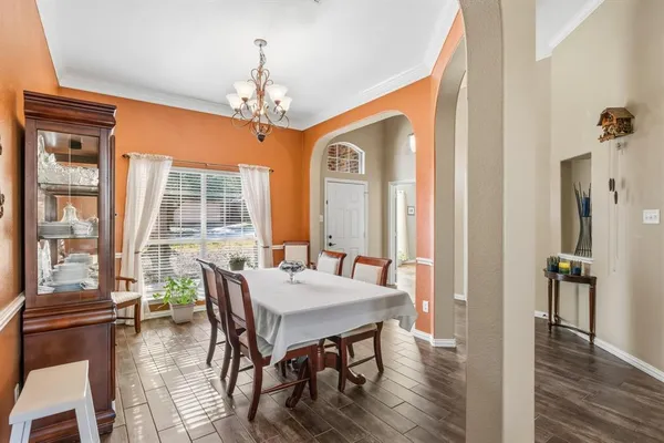 a view of a hallway and wooden floor and dining room