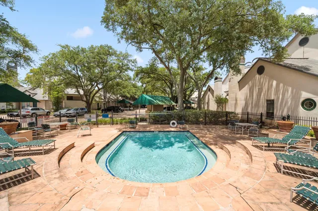 a swimming pool with outdoor seating and yard