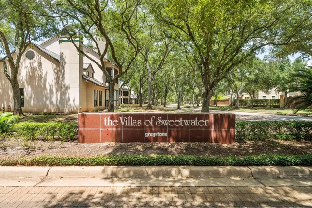 a sign that is sitting in front of a house