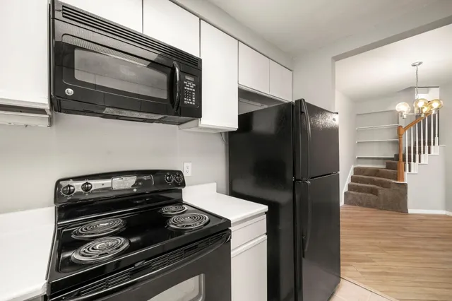 a kitchen with a refrigerator stove and microwave
