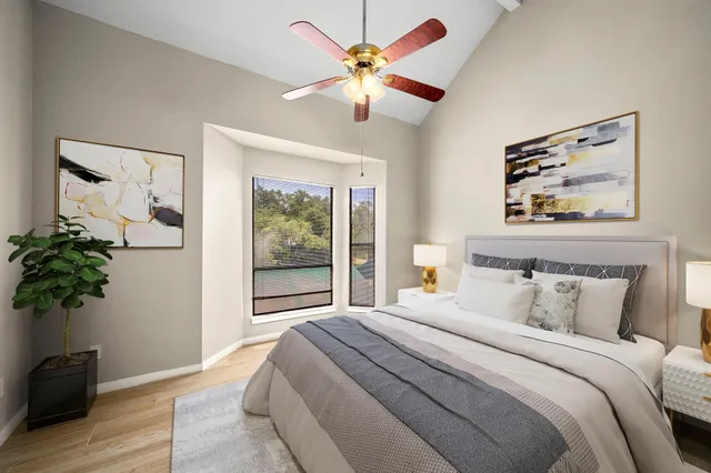 a bedroom with a bed and a potted plant