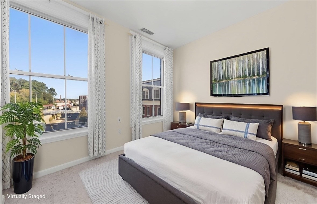 80 Wingate Street, Unit 4C Haverhill, MA 01832 - Photo 15 of 27 a bedroom with a large bed and a potted plant