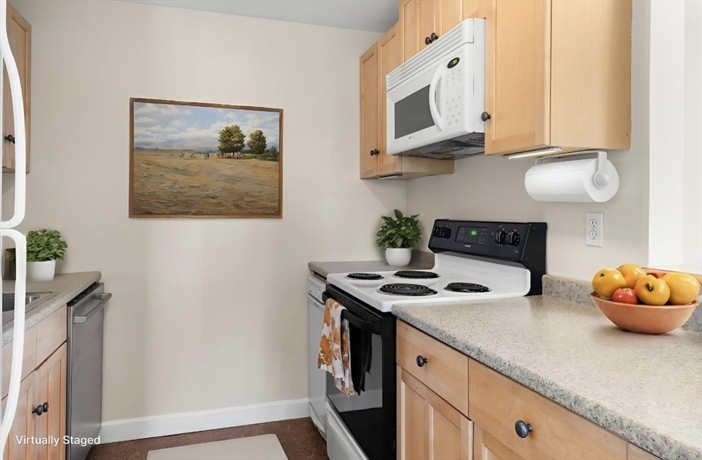 80 Wingate Street, Unit 4C Haverhill, MA 01832 - Photo 4 of 27 a kitchen with stainless steel appliances granite countertop a sink a stove and a wooden floors