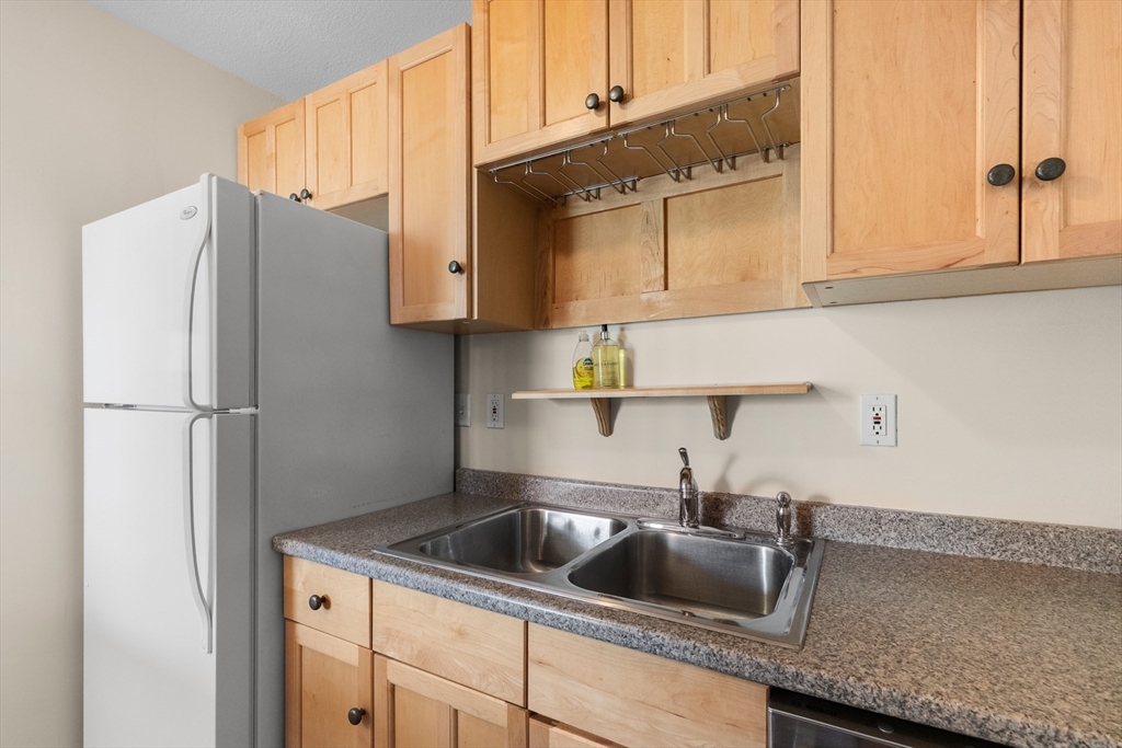 80 Wingate Street, Unit 4C Haverhill, MA 01832 - Photo 5 of 27 a kitchen with stainless steel appliances granite countertop a sink a refrigerator and a cabinets