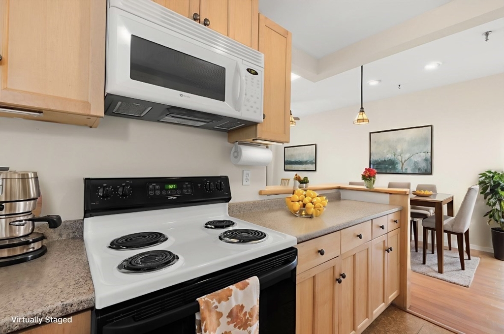 80 Wingate Street, Unit 4C Haverhill, MA 01832 - Photo 7 of 27 a kitchen with a stove and a microwave