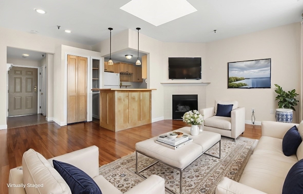 80 Wingate Street, Unit 4C Haverhill, MA 01832 - Photo 8 of 27 a living room with furniture a flat screen tv and a fireplace