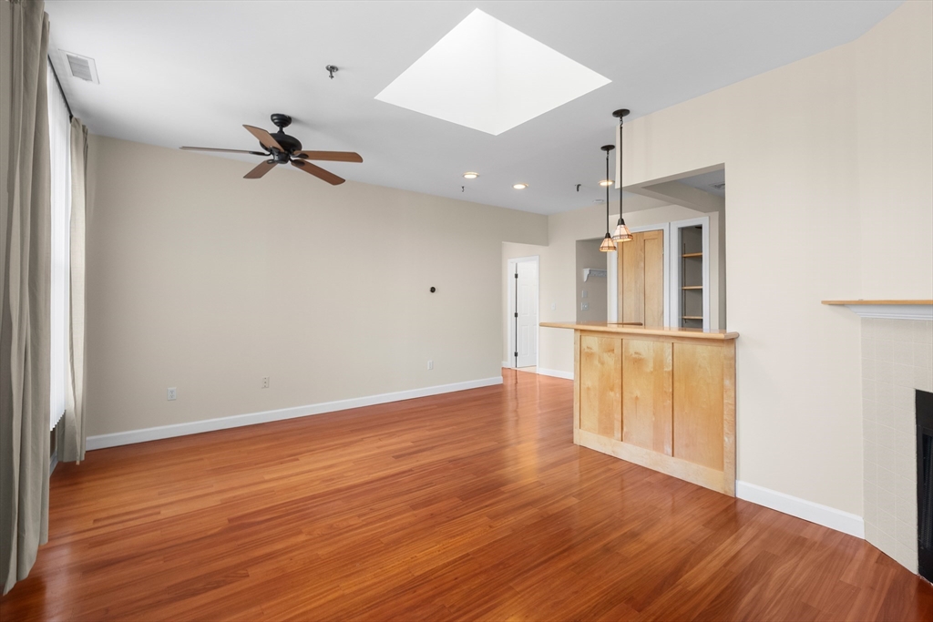 80 Wingate Street, Unit 4C Haverhill, MA 01832 - Photo 10 of 27 a view of empty room with wooden floor and ceiling fan
