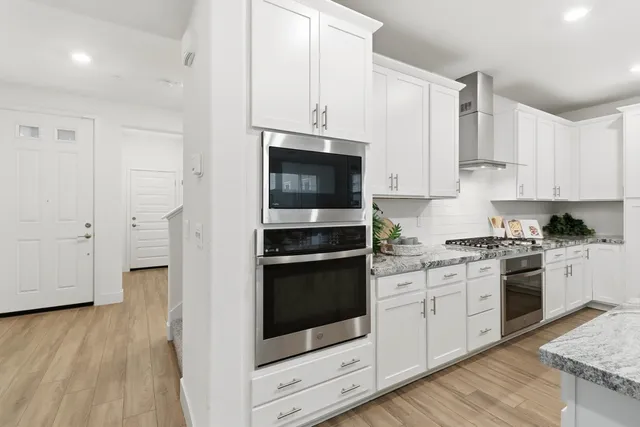 a large kitchen with stainless steel appliances
