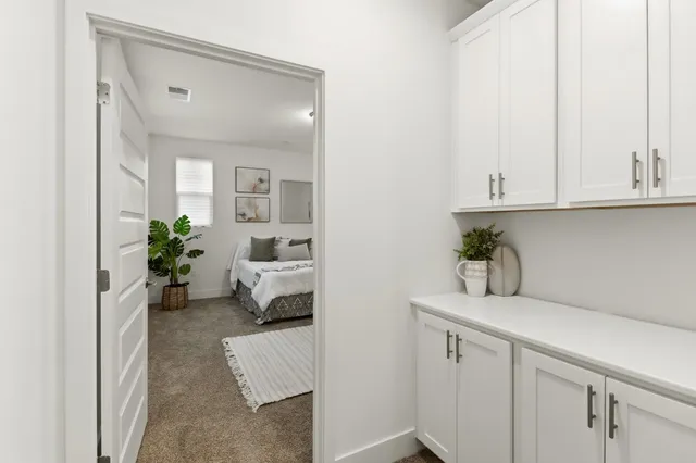 a bedroom with a bed table chair and a couch