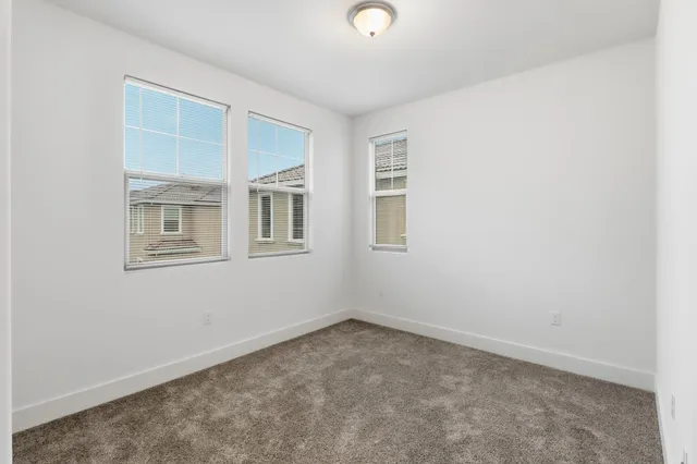 an empty room with windows and closet