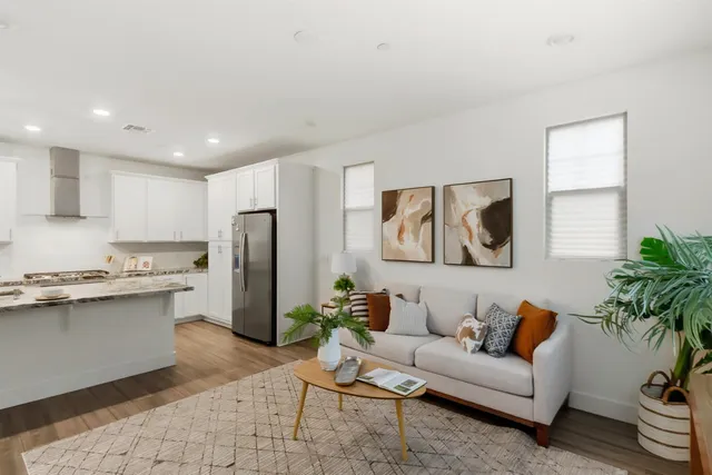 a living room with furniture and wooden floor