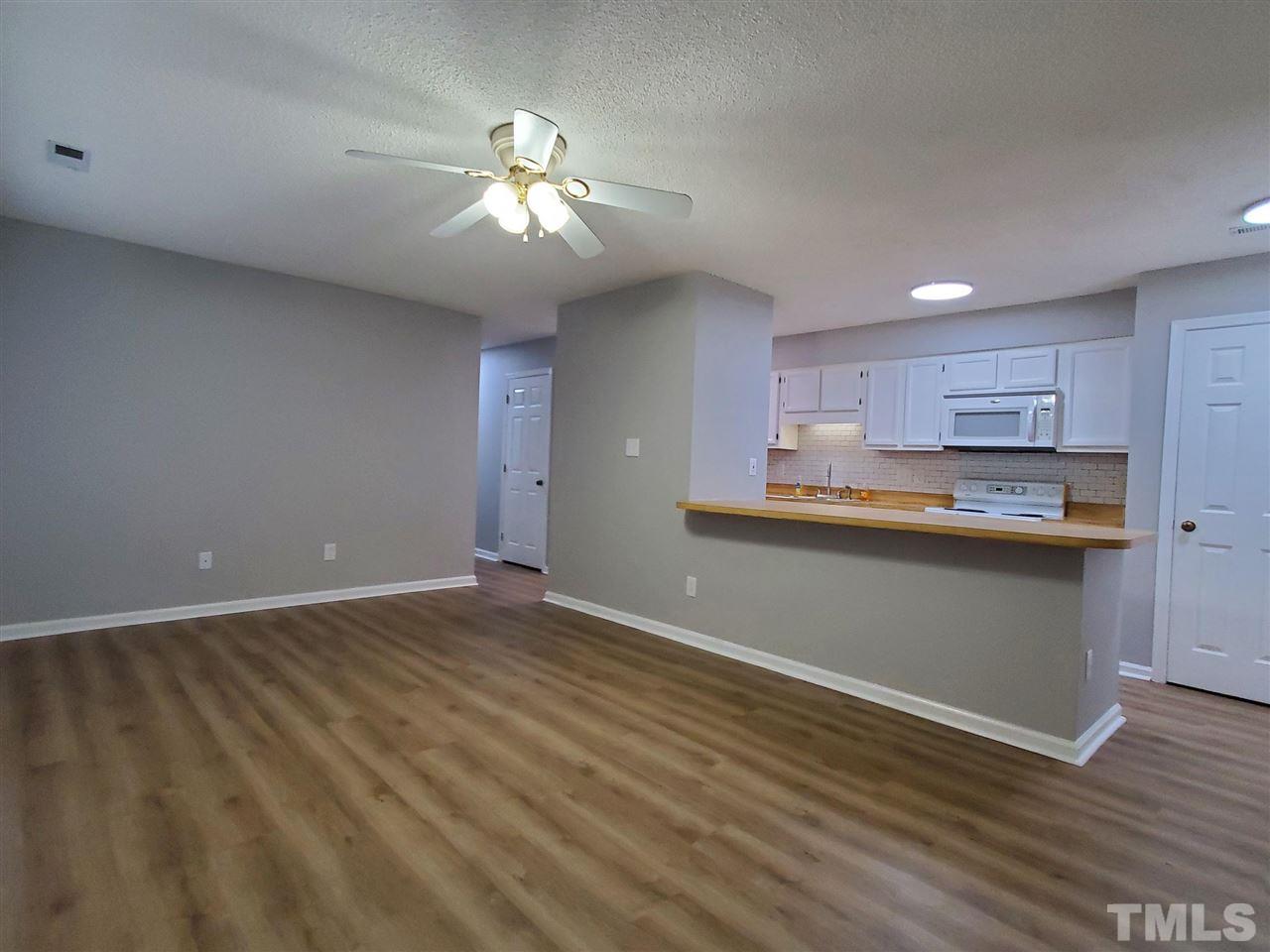 2011 Quaker Landing, Unit 103 Raleigh, NC 27603 - Photo 3 of 11 New LVP flooring and fresh paint (light grey walls with white trim) show off this wonderful space