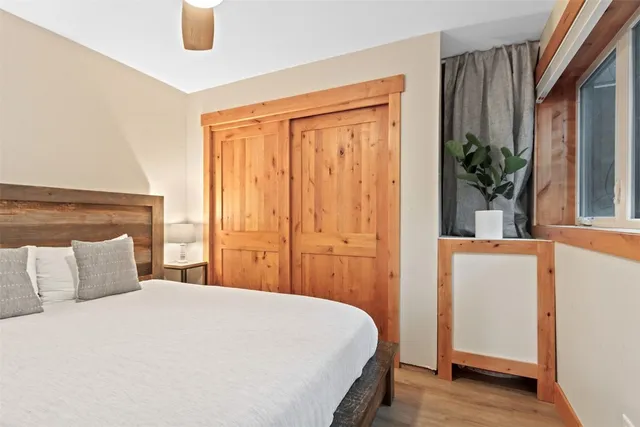 a bedroom with a bed and a potted plant