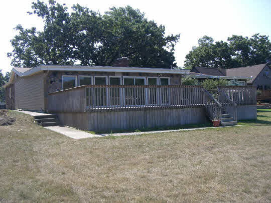 6308 Park Ridge Road Loves Park, IL 61111 - Photo 3 of 6 a view of backyard with wooden fence and trees