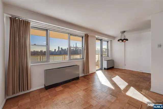 an empty room with large windows