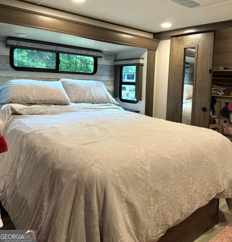 a bed room with a bed and a mirror