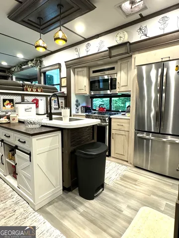 a kitchen with a sink appliances and cabinets