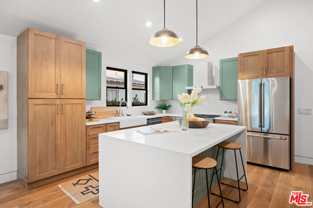 5252 Range View Avenue Los Angeles, CA 90042 - Photo 14 of 41 a kitchen with refrigerator cabinets and wooden floor